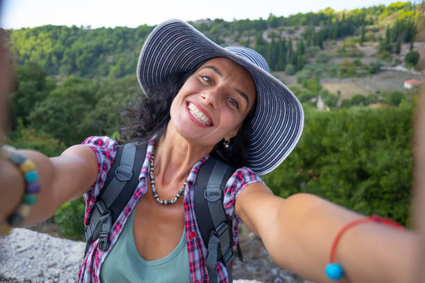 istock Female backpacker relaxing and taking selfie while enjoying summer vacations in Zakynthos Greece 1346122750