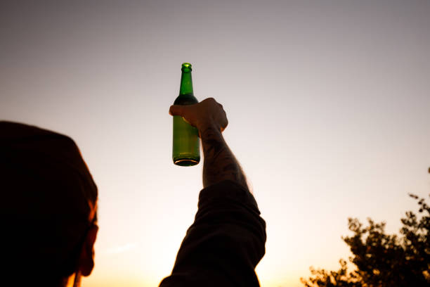 istock Unrecognizable man with beer against the sky. 1346123905