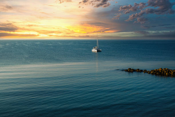 istock Sailing boat in the morning sun on the coast 1346124236