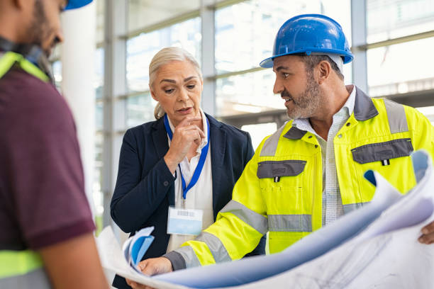istock Mature engineer and contractor woman discussing at construction site 1346124888