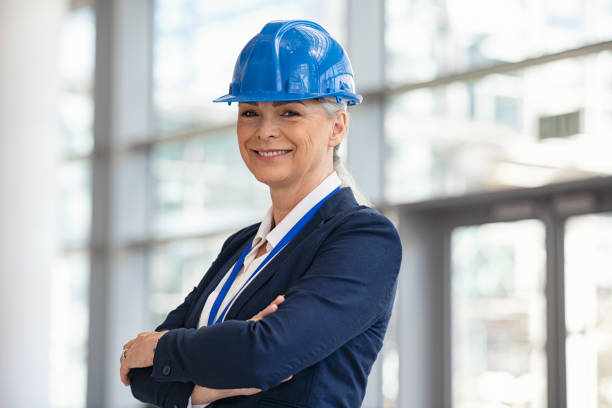 istock Portrait of mature architect with hardhat at construction site 1346124891