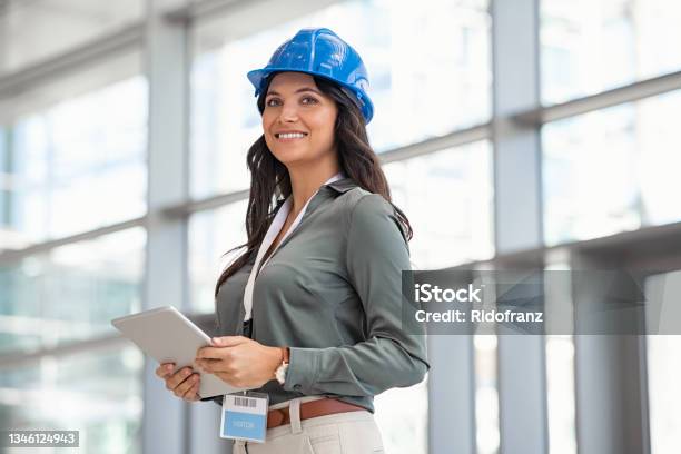 Architect Working On Digital Tablet At Construction Site Stock Photo - Download Image Now