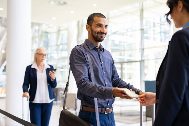 istock Happy mixed race man showing electronic flight ticket 1346125111