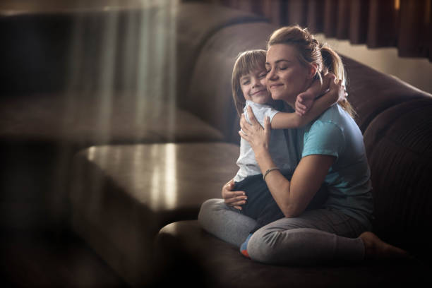 istock Affectionate single mother and son embracing at home. 1346125332