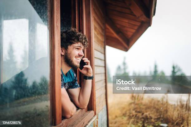 Tell Your Friends About Your Adventures Stock Photo - Download Image Now - Log Cabin, People, Using Phone