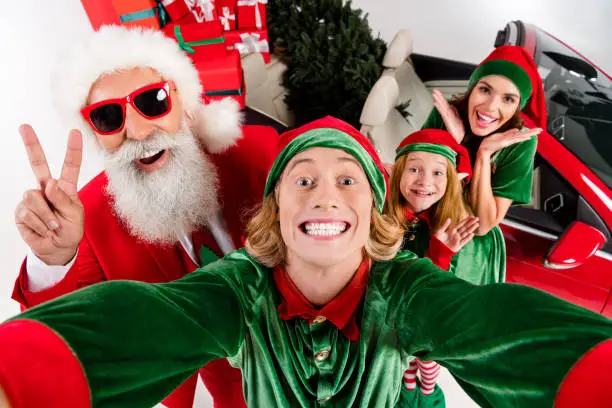 Photo of four people take selfie showing v-sign prepare x-mas eve party service isolated on white color background.