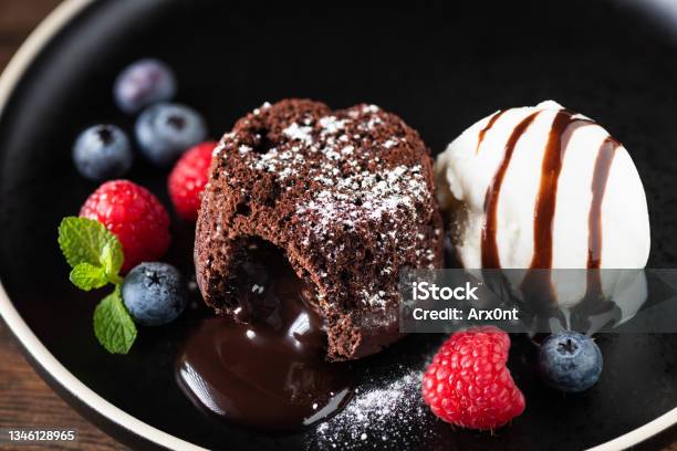Chocolate Fondant Cake With Ice Cream Scoop Stock Photo - Download Image Now - Chocolate, Backgrounds, Baked