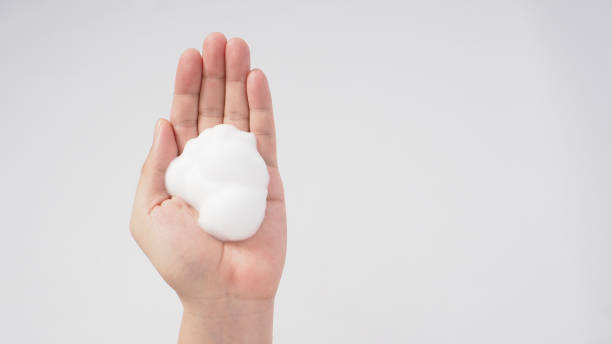 istock Hands washing gesture with foaming hand soap on white background. 1346129247