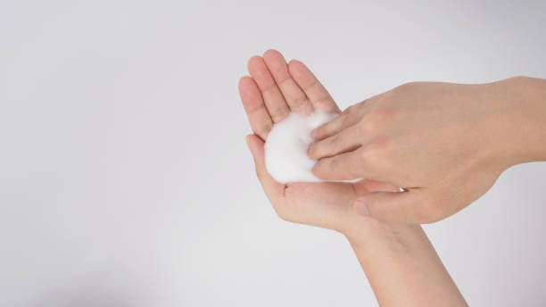 istock Hands washing gesture with foaming hand soap on white background. 1346129262
