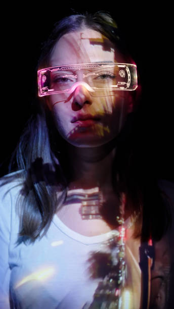 istock Projection on a woman's face wearing futuristic glasses 1346129348