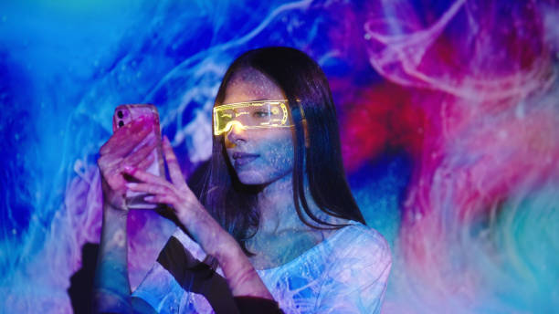 Video projection on a woman using a smart phone stock photo