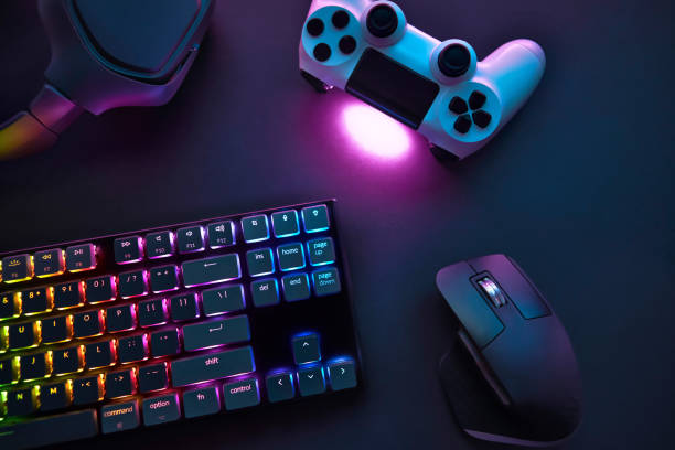 istock Top down view of various gaming accessories laying on table. Colorful illuminated devices. 1346129406