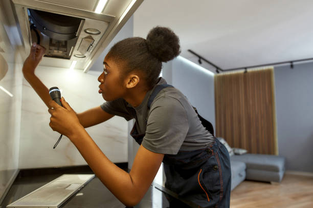 istock Professional female repair worker troubleshooting kitchen hood 1346129818