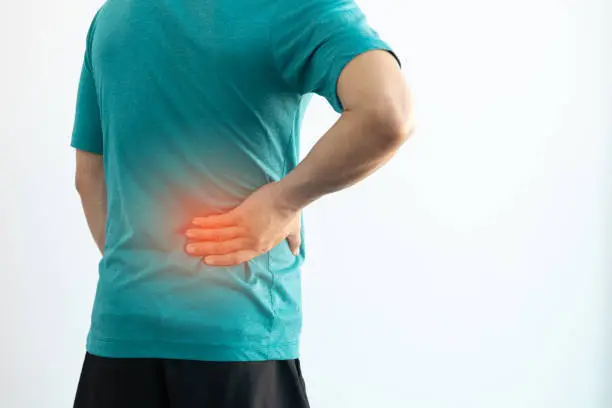 Photo of Close-up man having back pain and lumbago.