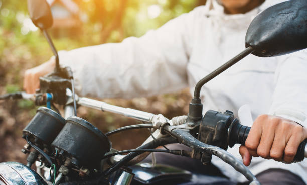 istock The motorcyclist is controlling the car while driving. 1346131099
