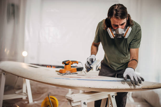 istock Man renovating his windsurfing board 1346131477