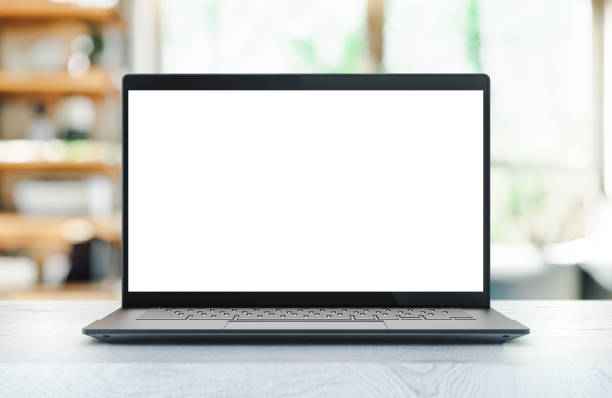 istock Laptop PC with blank screen on white wooden table in home interior - mockup template 1346131858