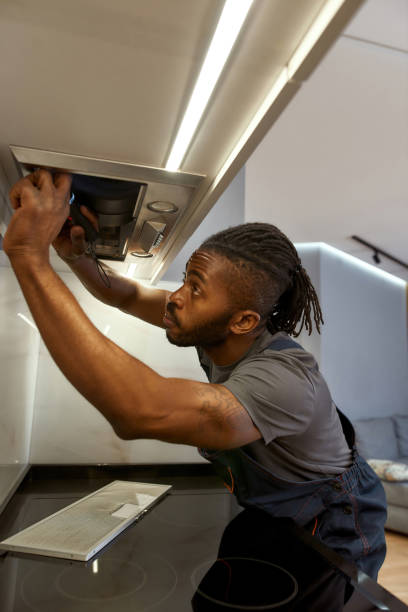istock Skilled African electrician repairing kitchen extractor filter 1346133549