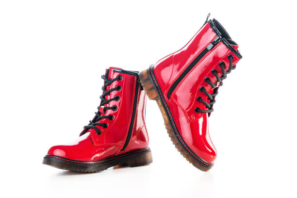 istock Red shiny leather shoes. Shining boots isolated on white background 1346133669
