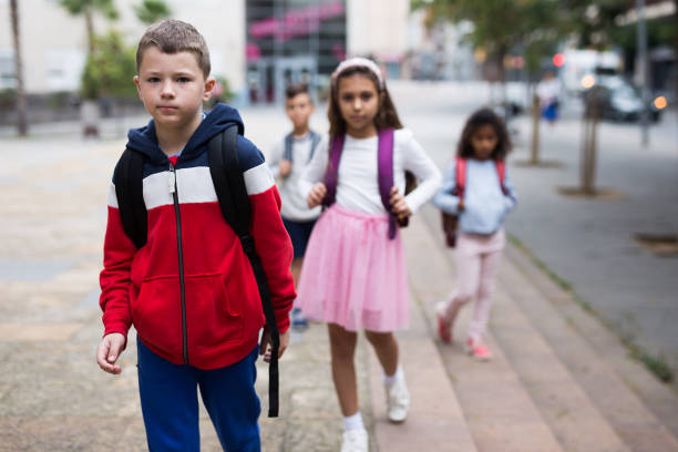 istock Tween boy with backpack walking to school campus after lessons 1346134514