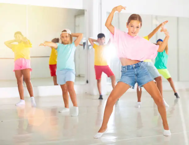 Photo of Tween girl breakdancer posing during group dance class