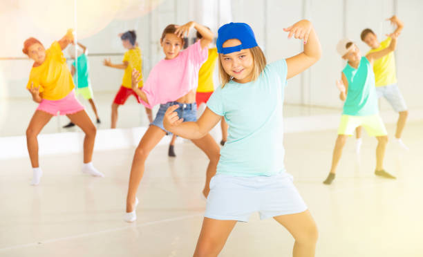 istock Group of children are learning dance moves in modern studio 1346135508