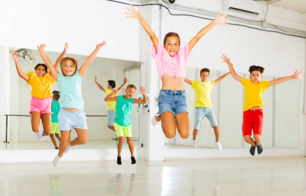 istock Children jumping while studying modern style dance in class indoors 1346135523