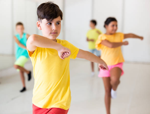 istock Preteen boy dancing lezginka during group class in choreographic studio 1346135598