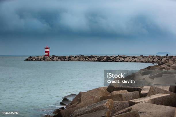 Safety Beacon And Rain Clouds In Scheveningen Stock Photo - Download Image Now - Scheveningen, Bay of Water, Beach