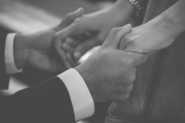 istock Man holding woman’s hand, caring, praying 1346136066