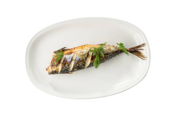 Hot smoked herring fish on white plate isolated on white background stock photo