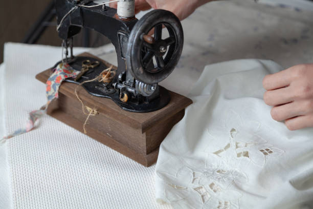 istock Manual sewing machine stands on white fabric 1346137036