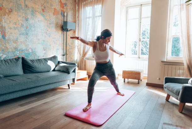 istock woman doing yoga at home 1346137360