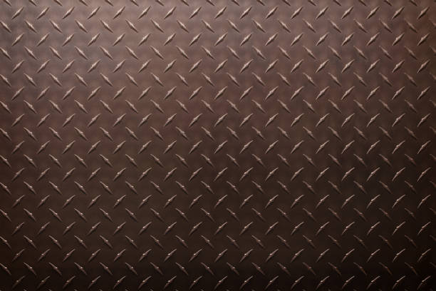 istock brown iron plate with diamond texture, dark metal background. 1346137379