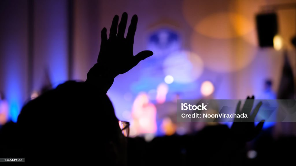 Hand raising concert, Hand raising for religion Silhouette hands Praising - Religion Stock Photo