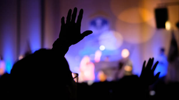 Hand raising concert, Hand raising for religion Silhouette hands sing praise stock pictures, royalty-free photos & images