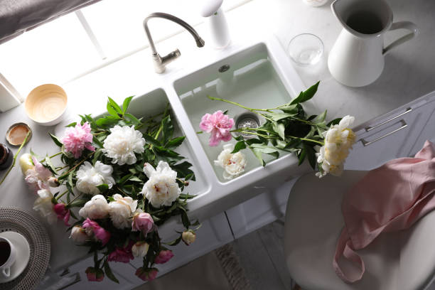 istock Bunch of beautiful peonies in kitchen sink, above view 1346141172