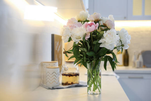 istock Beautiful peonies in vase on kitchen counter 1346142160