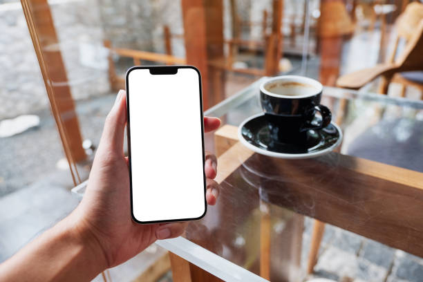 istock a man holding mobile phone with blank white screen in cafe 1346142187