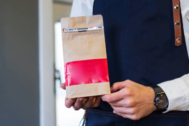 istock barista holding a coffee pack 1346142197