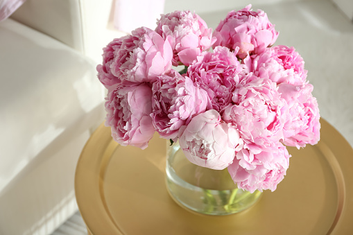 Bouquet of beautiful peonies on table indoors