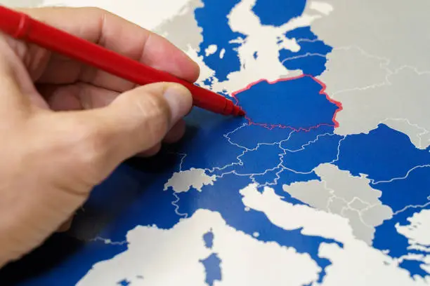 Photo of Hand drawing a red line between Poland and the rest of EU, Polexit concept.