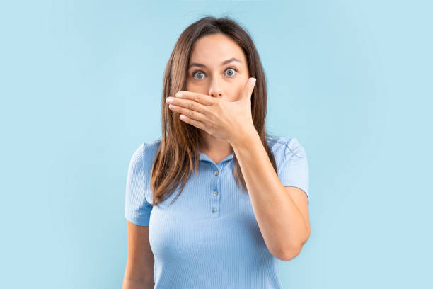 istock Surprised woman covers her mouth 1346142883