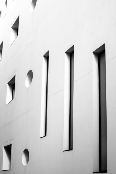 istock Square and round geometric shaped window on white facade 1346145858
