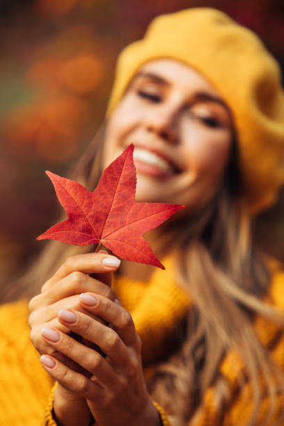 istock Beautiful woman holding a leaf 1346146158