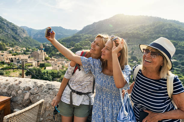 Teenage girl, mother and grandmother are sightseeing beautiful town of Valldemossa, Majorca, Spain stock photo