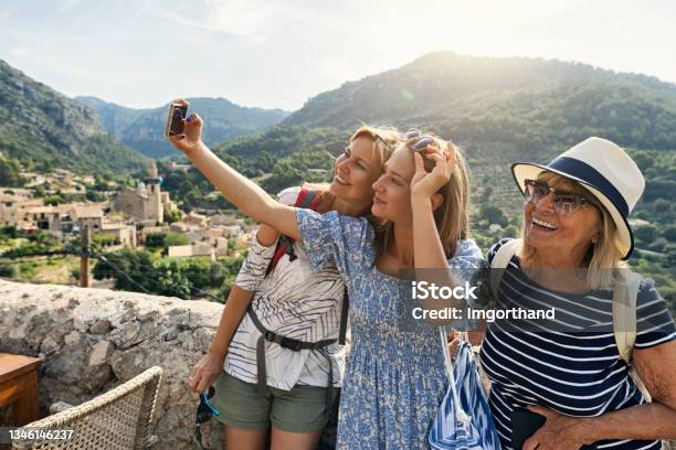 Teenage Girl Mother And Grandmother Are Sightseeing Beautiful Town Of Valldemossa Majorca Spain Stock Photo - Download Image Now