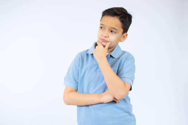 istock young caucasian boy thinking over white background 1346146358