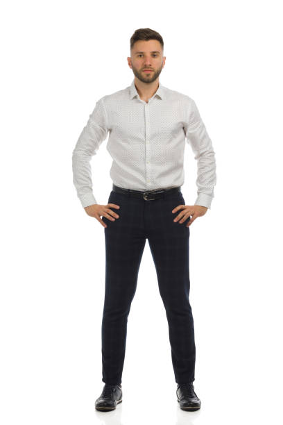 istock Serious elegant man is standing with hands on hip. Front view. Isolated. 1346148536