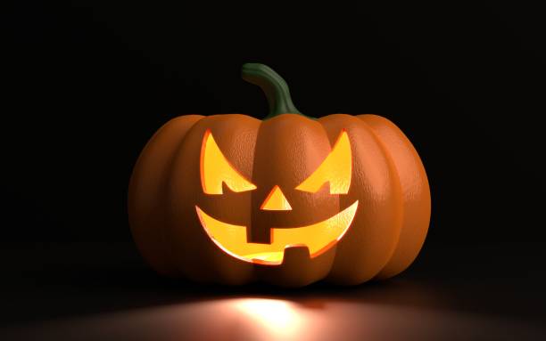 istock Carved Squash for Halloween Against Black Background 1346148573